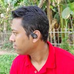 A smart boy sit in the nature wearing SoundPeats GoFree 2