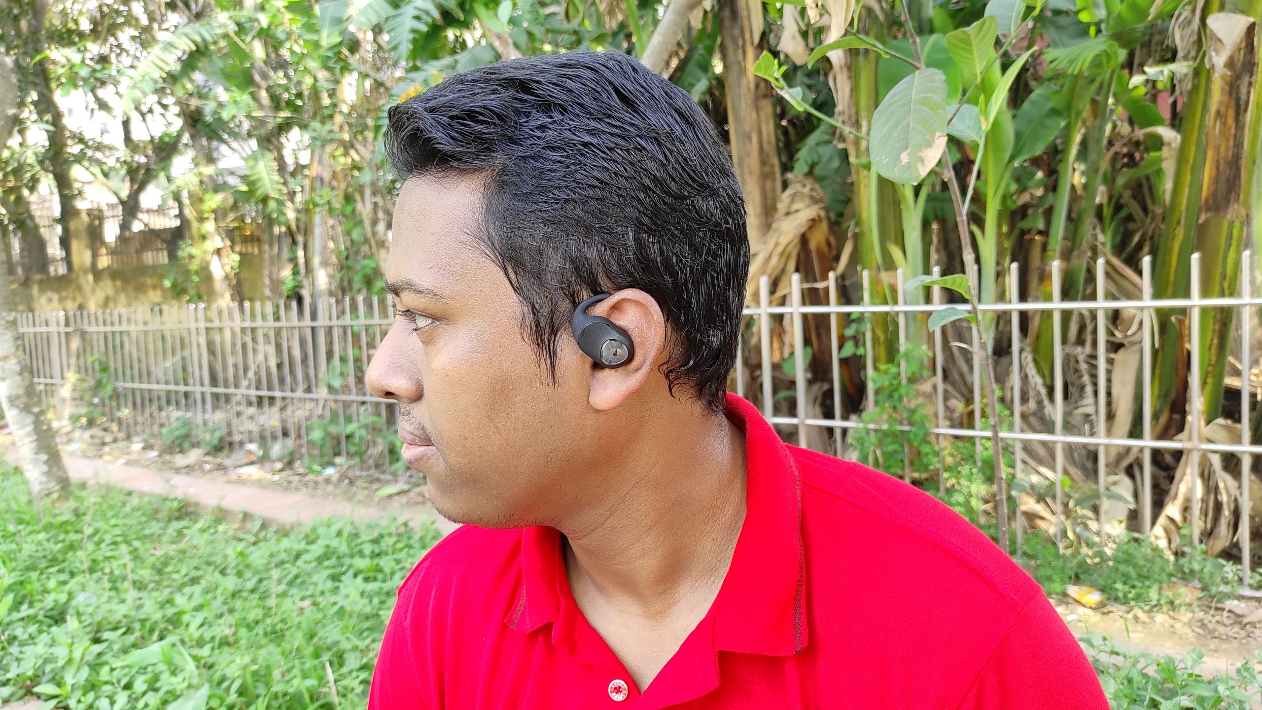 A smart boy sit in the nature wearing SoundPeats GoFree 2