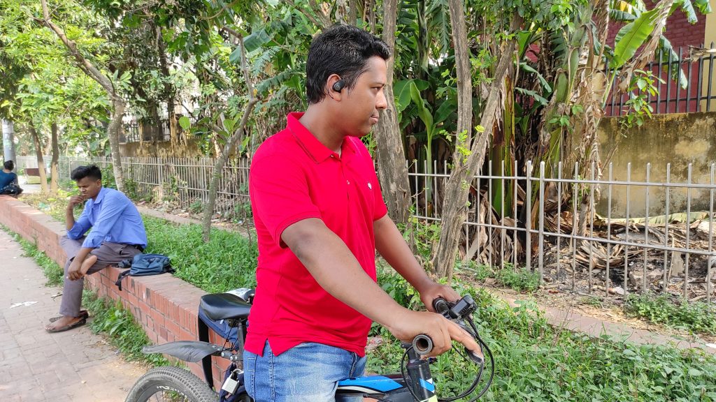 A smart boy wears a SoundPeats GoFree 2 open buds and riding cycle