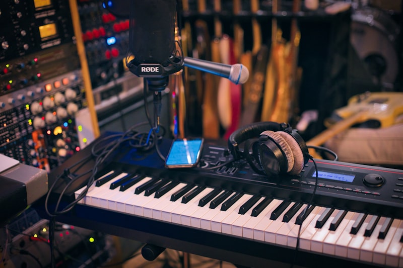 Audio engineer editing music using studio headphones in a home studio environment